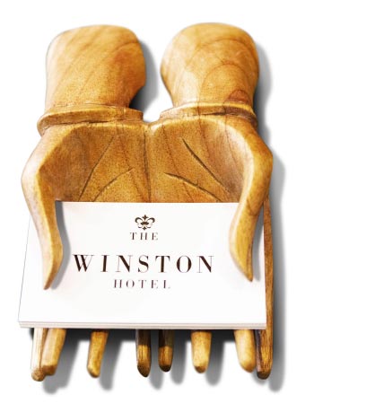Hotel business cards resting in wooden hands sculpture