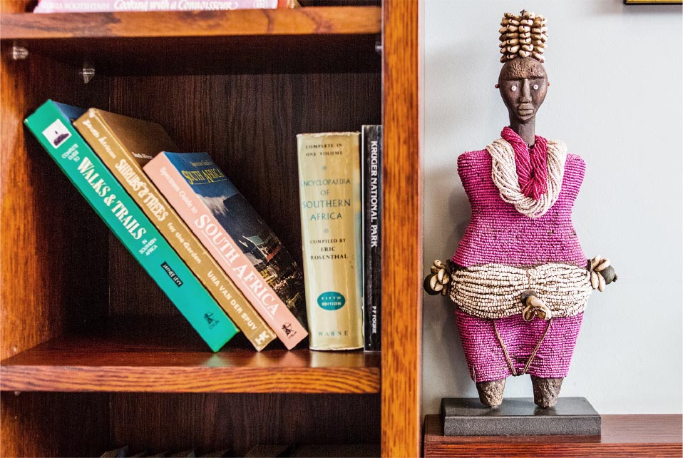african sculpture next to books