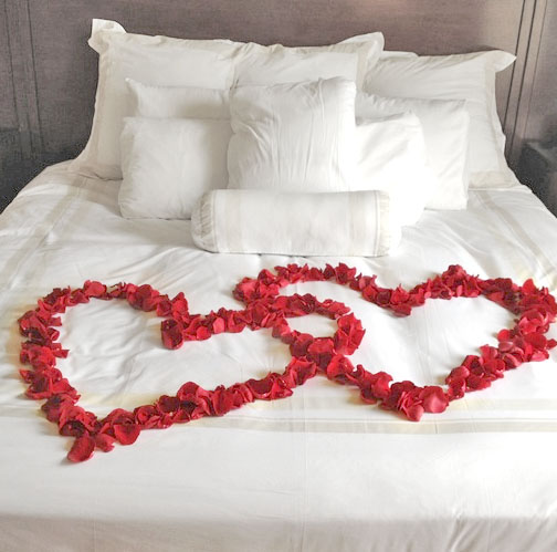 heart of flowers on bed